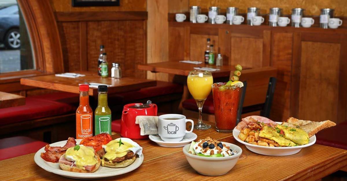 a restaurant table with plates and bowls of breakfast food