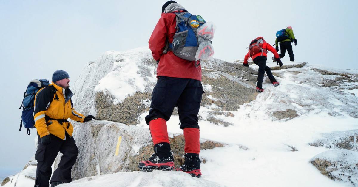 four winter hikers on a mountain