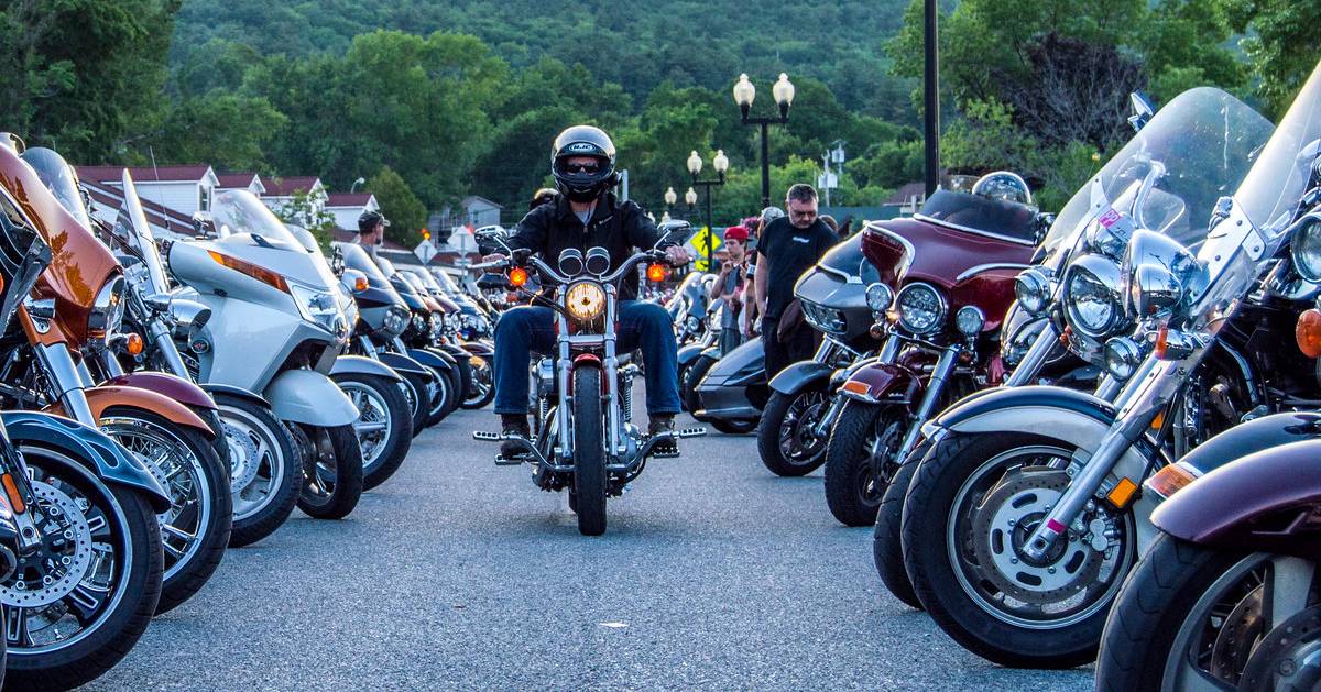 man on motorcycle in between more motorcycles