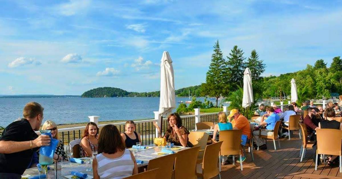 people dining outside by water