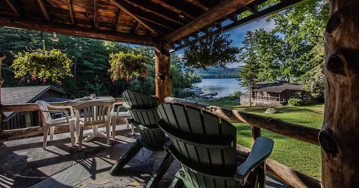 Adirondack chairs on deck with lake view