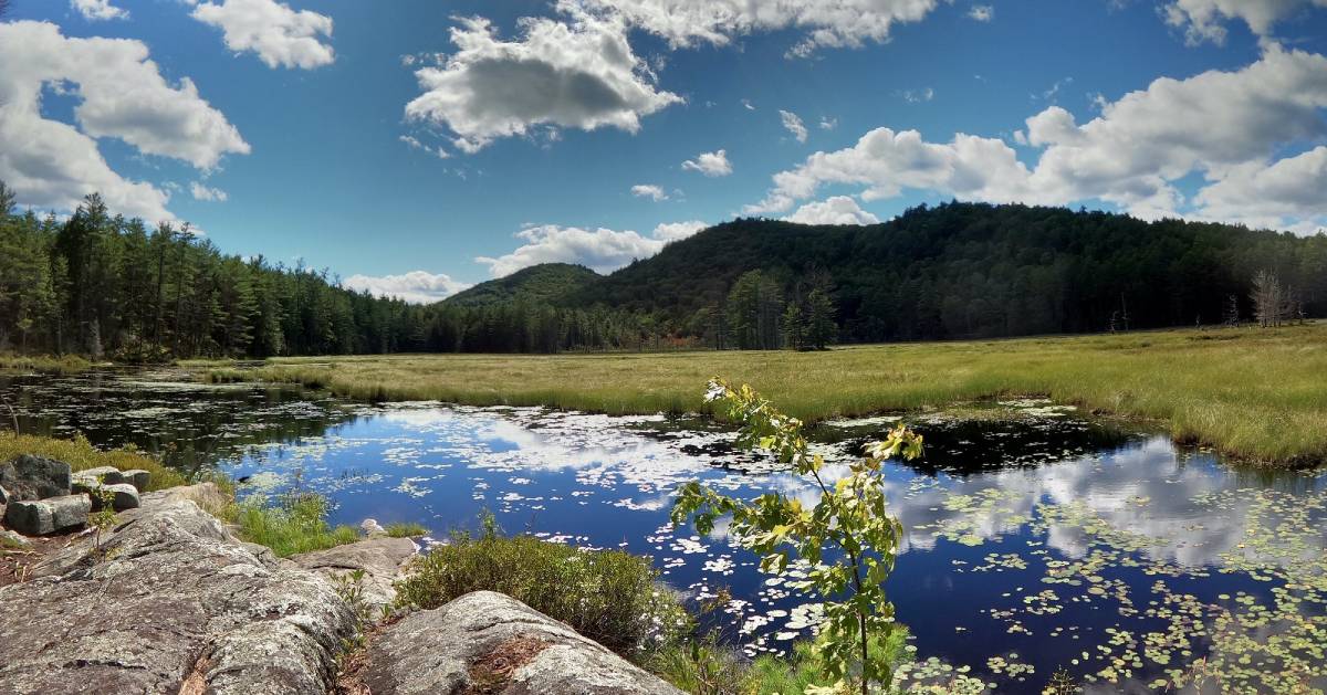 view of water and mountains and clouds on a nice day