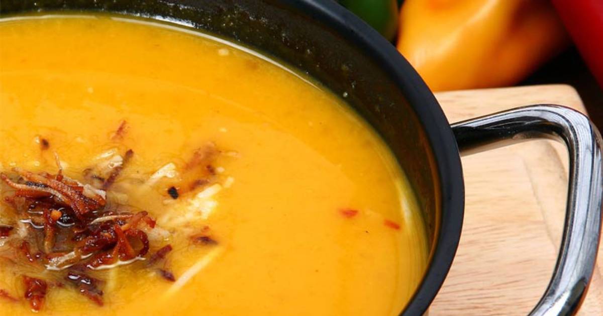close up of squash soup with a dollup of bacon