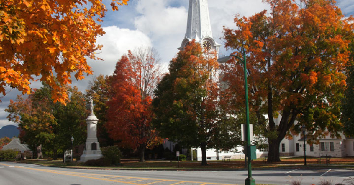 a church in Manchester with beautiful orange and red fall foliage on trees surrounding it