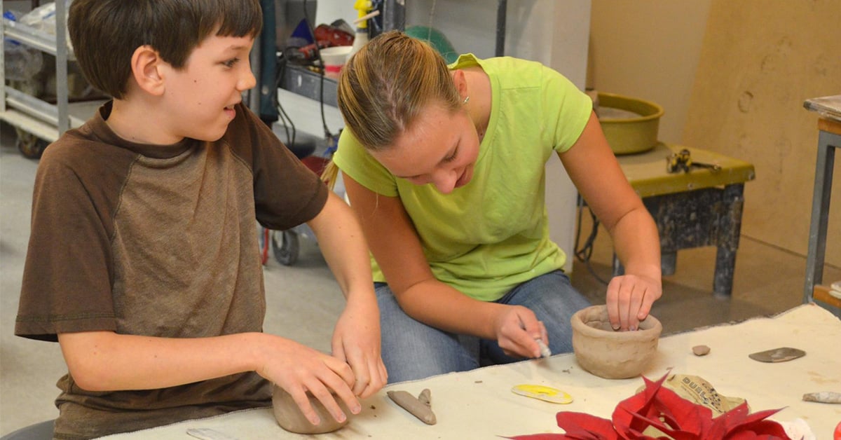 two kids working with clay