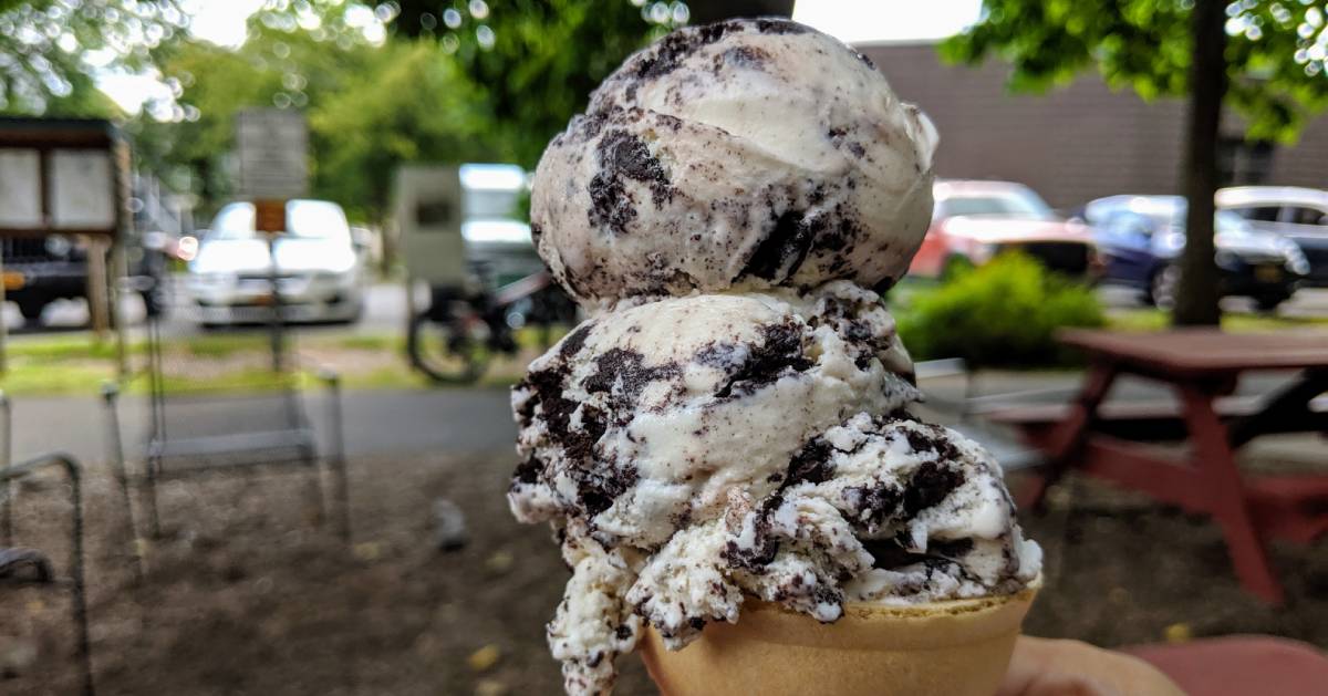 ice cream cone being held up