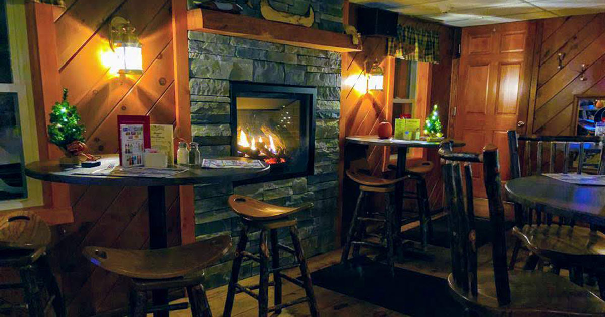 a restaurant with a fire in the fireplace