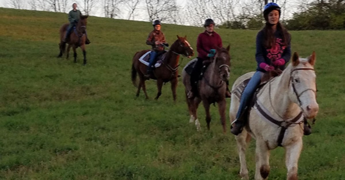 group of people riding horses