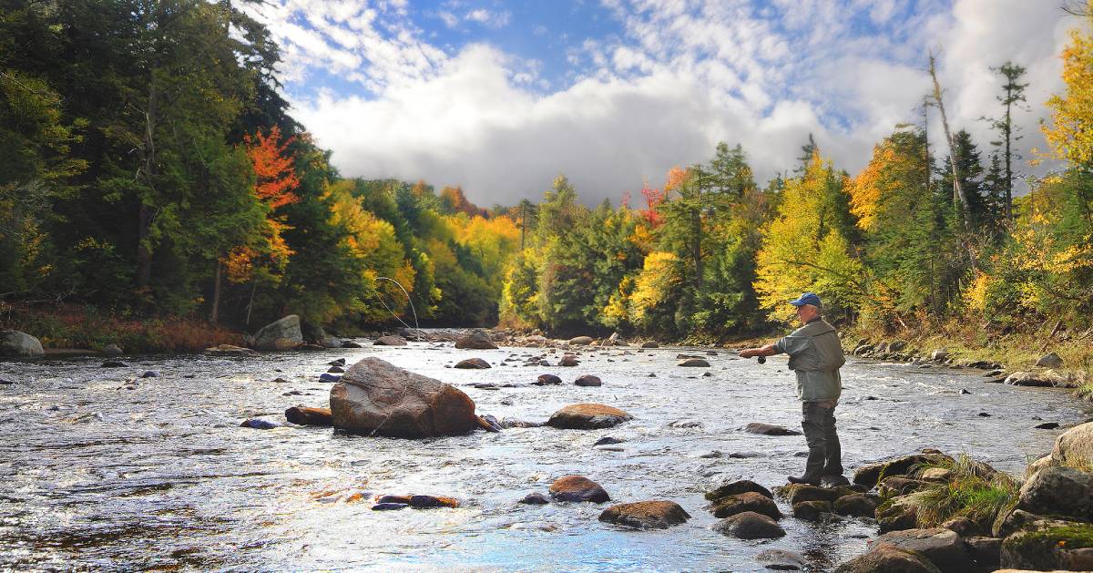 person fishing in Adirondacks during fall
