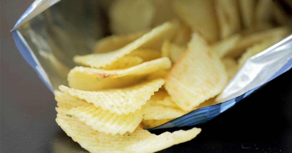 an open bag of chips with chips pouring out