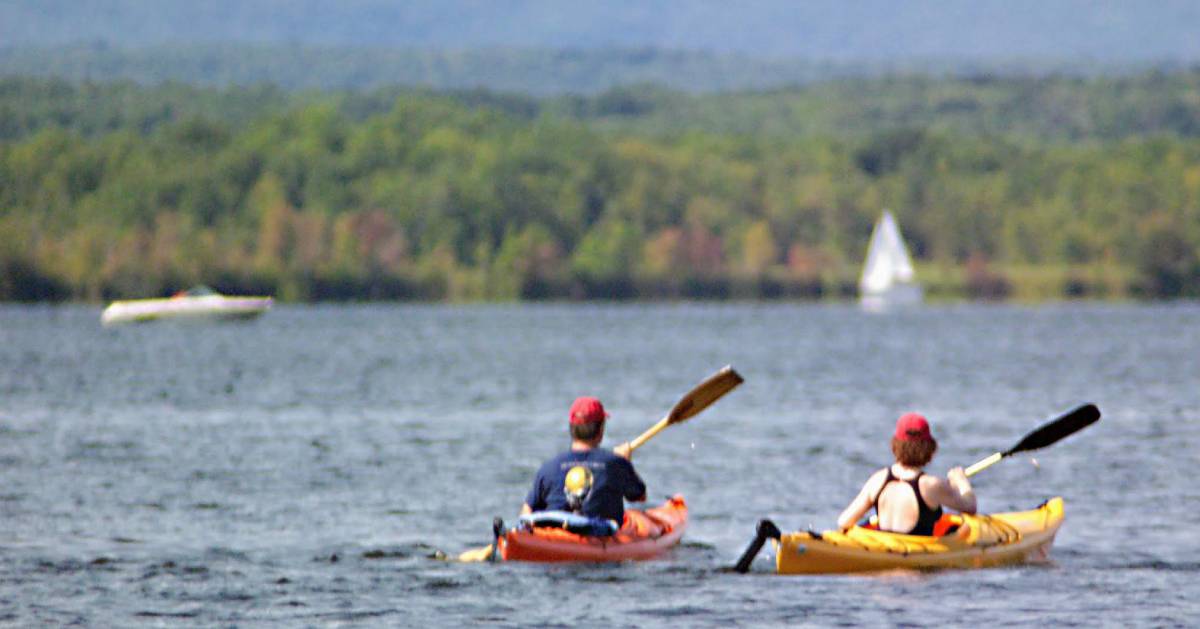 two kayakers on the water in the fall