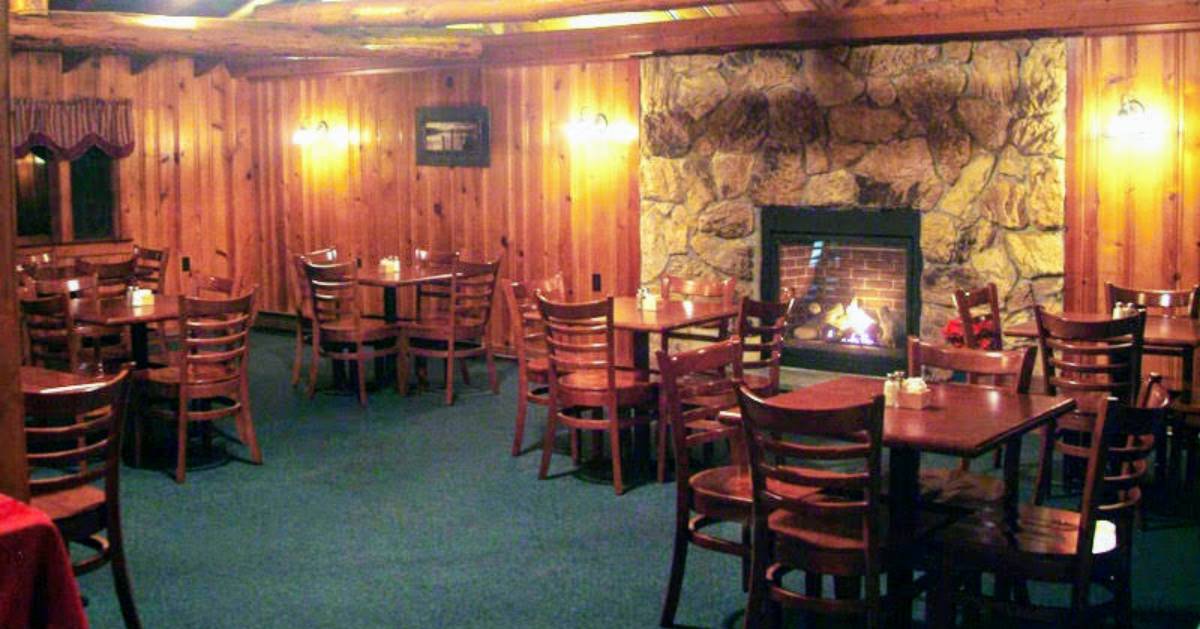 dining room with a fireplace in the back