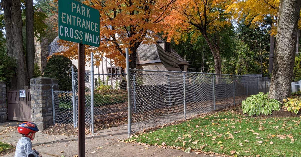 park entrance crosswalk sign in fall