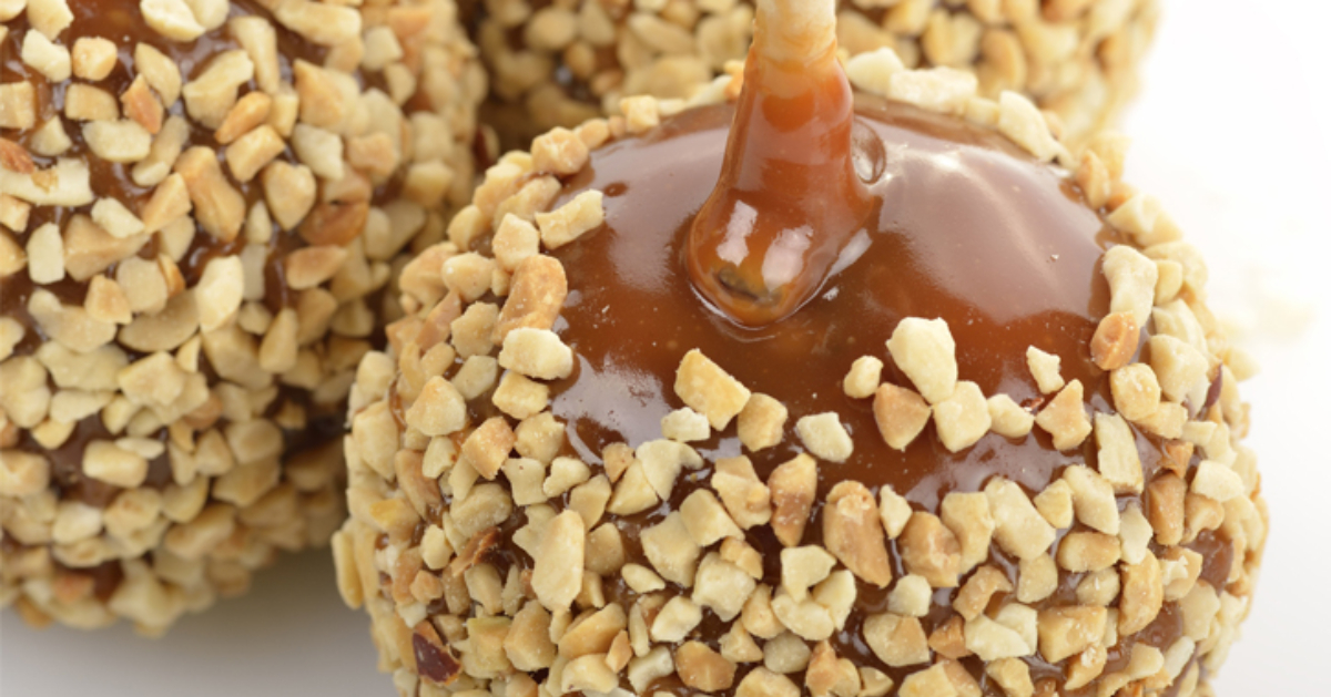 close up of caramel apples covered with nuts