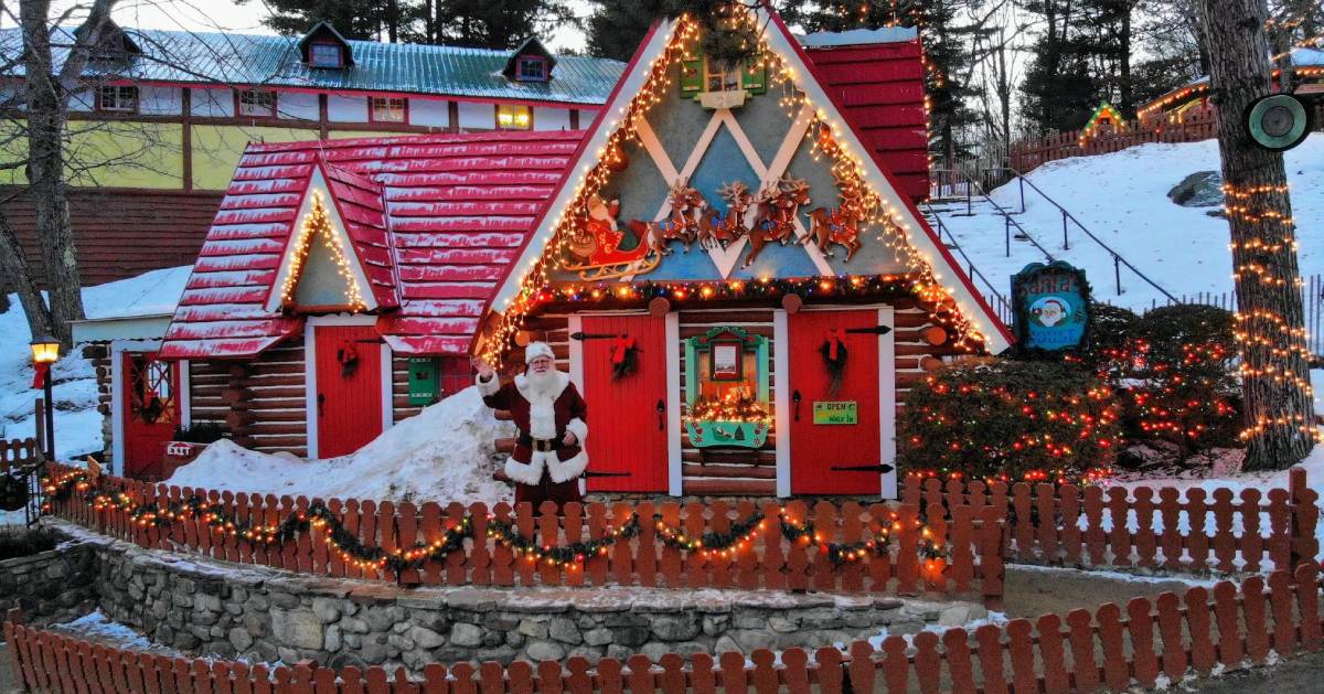 Santa standing in front of his house waving