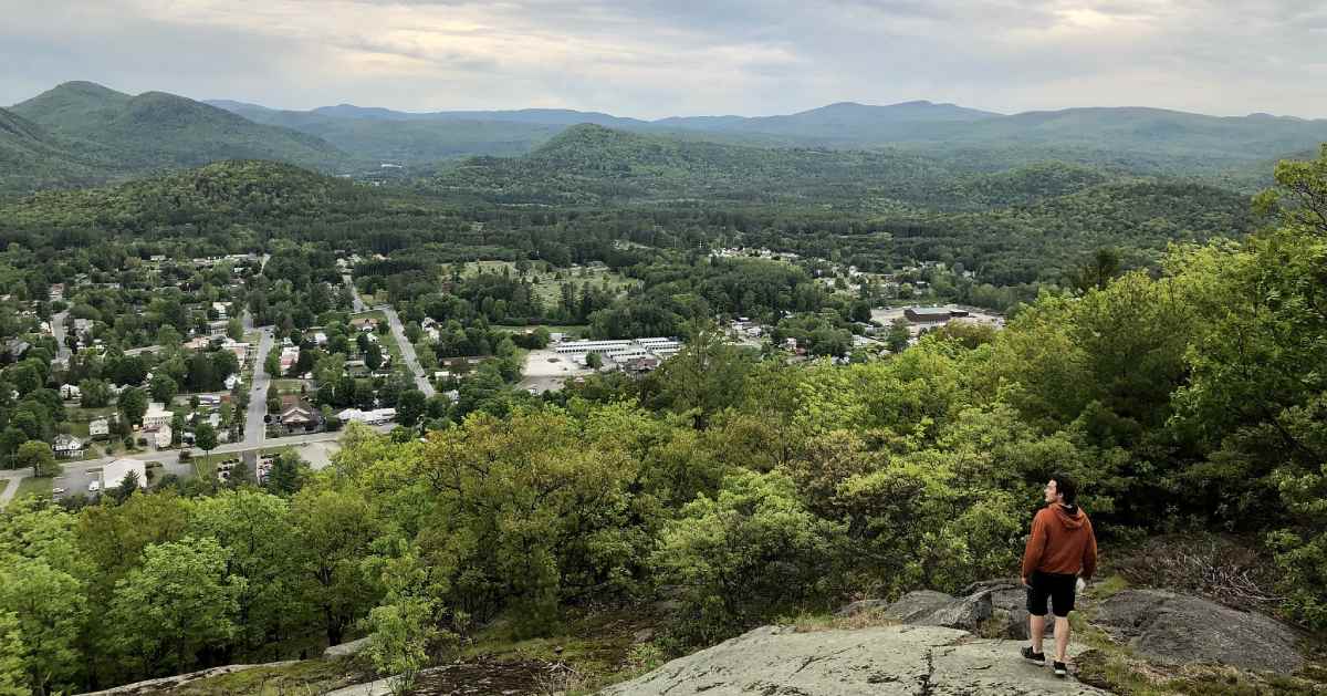 man looking at view from summit