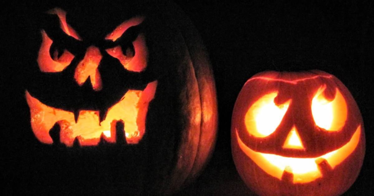 two jack o lanterns illuminated at night