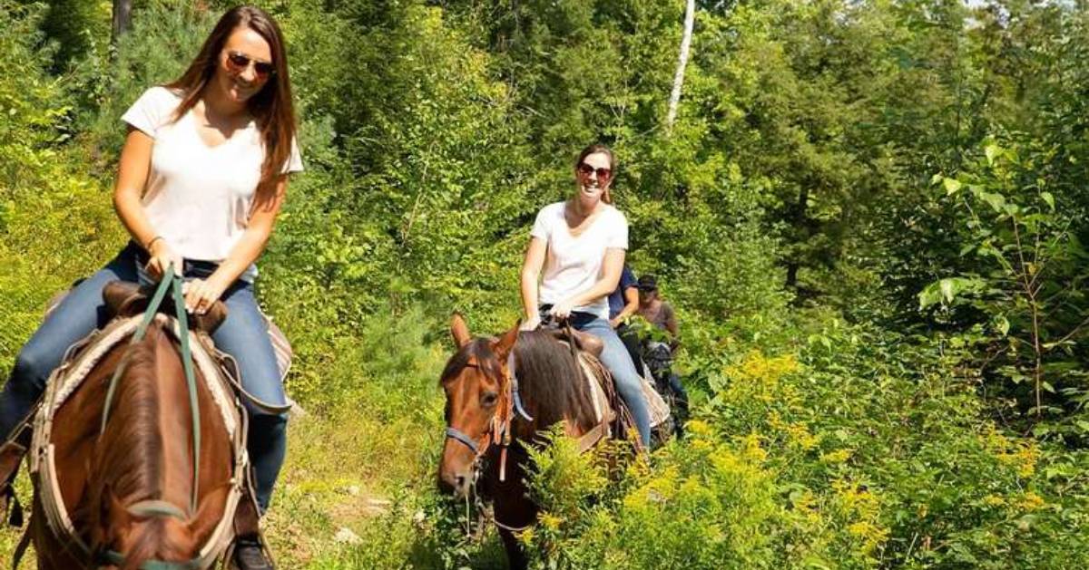 two young women horseback riding