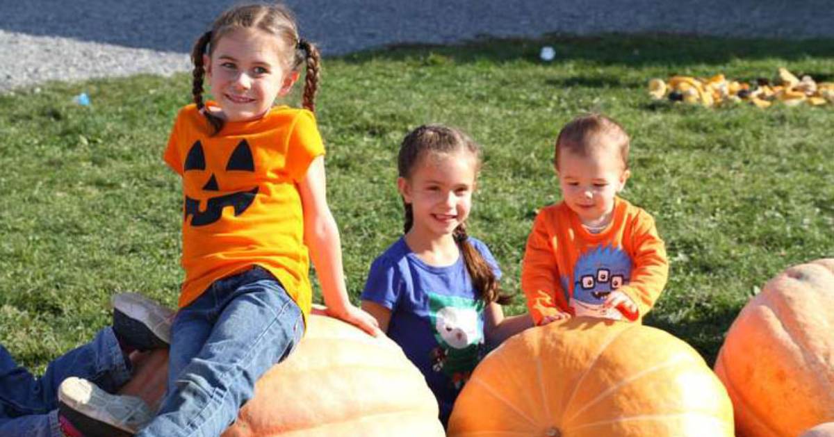 young kids on pumpkins