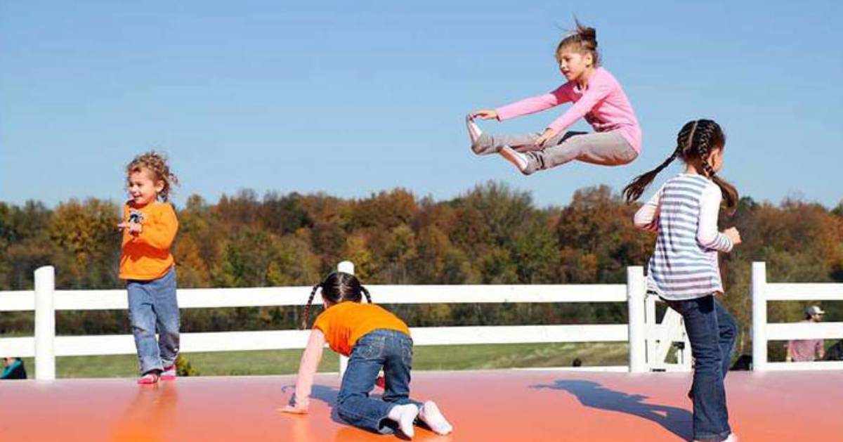 young kids on large orange jump pad