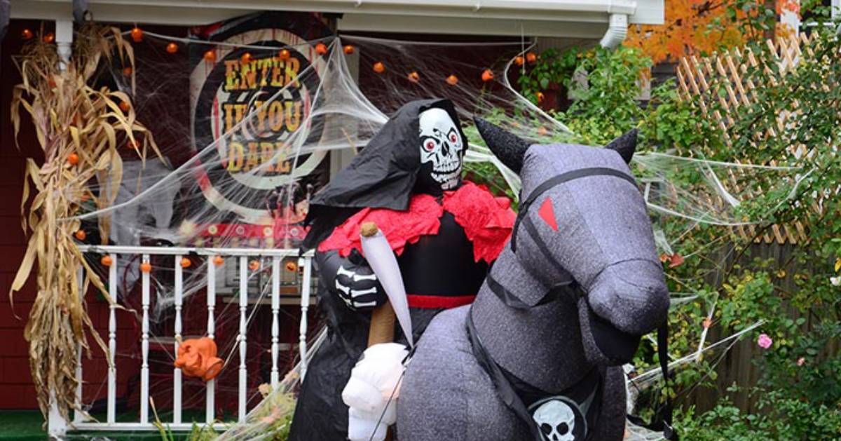 Halloween decorations at house, including blow up skeleton on horse