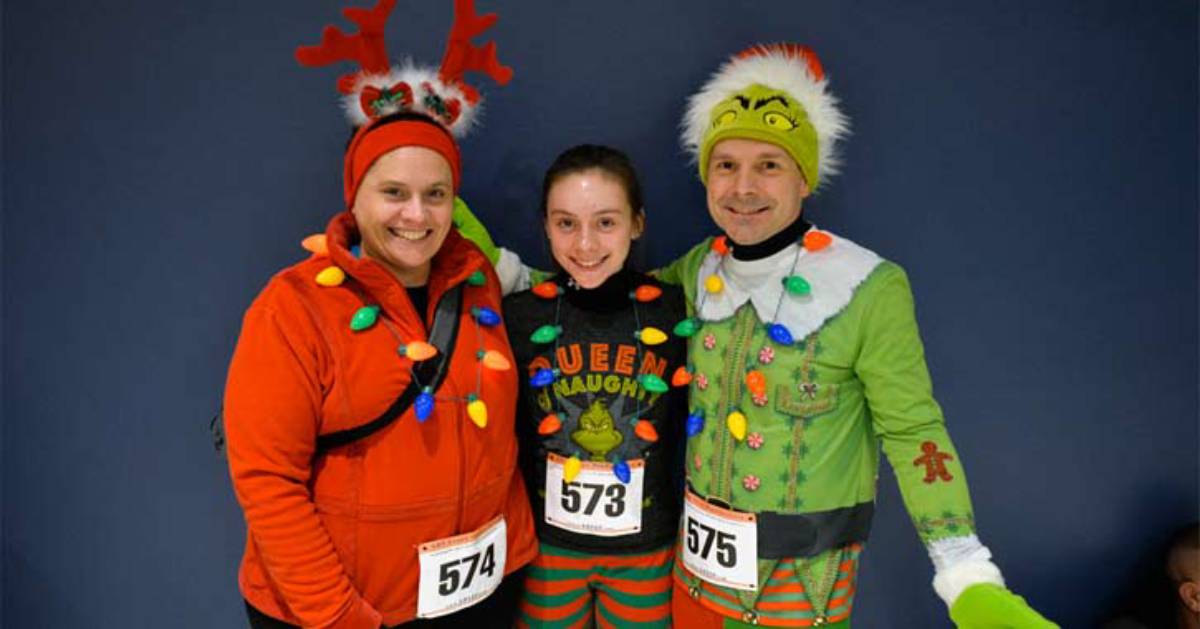 three people wearing holiday themed running attire