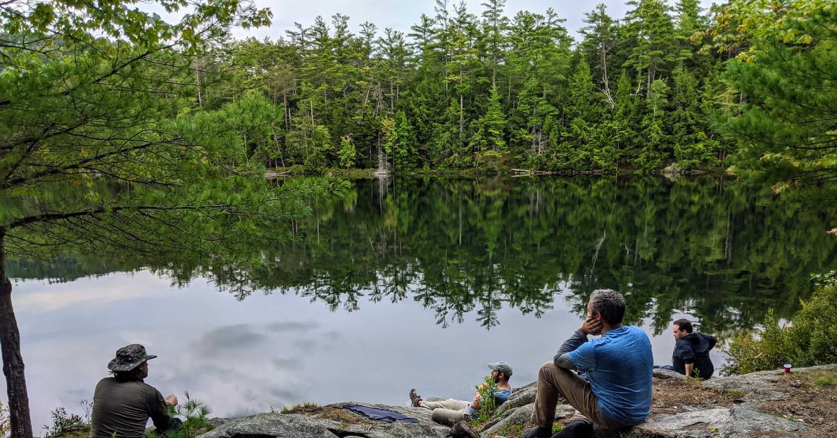 hikers resting by water