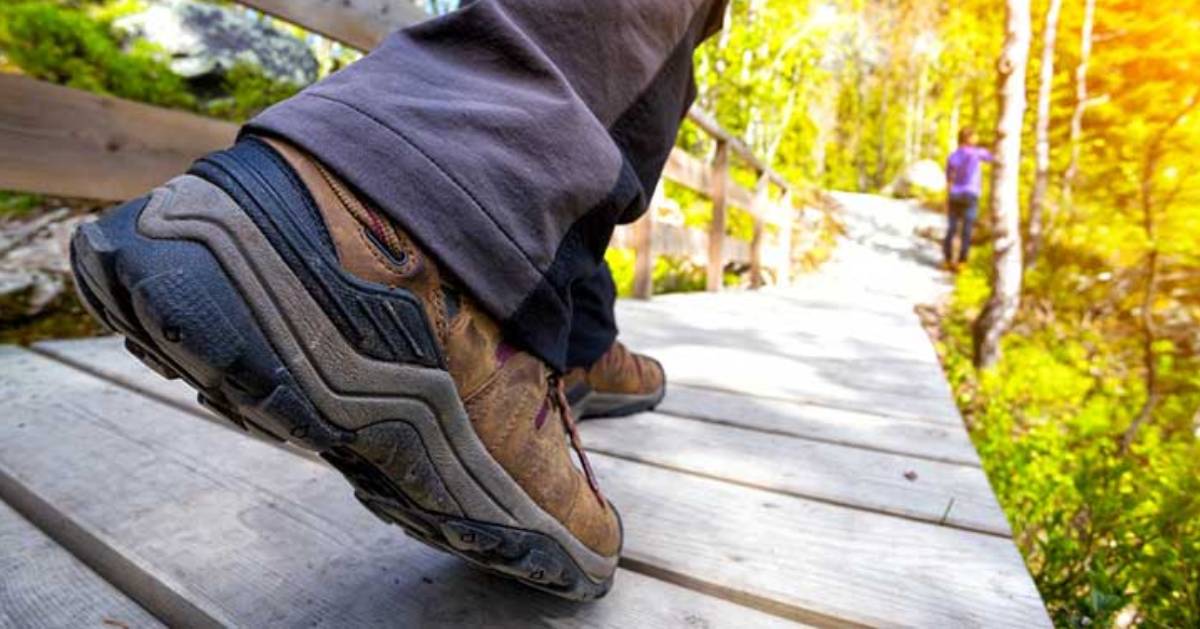 Close up of new hiking boots on wooden pathway