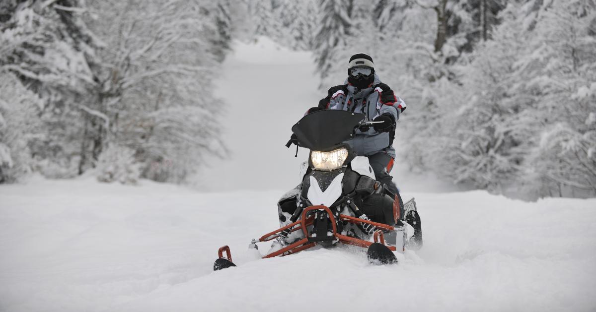 a snowmobiler in a snowy area