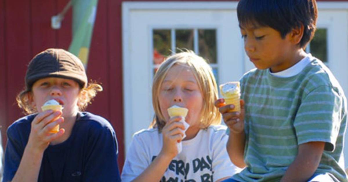 three kids eating ice cream cones