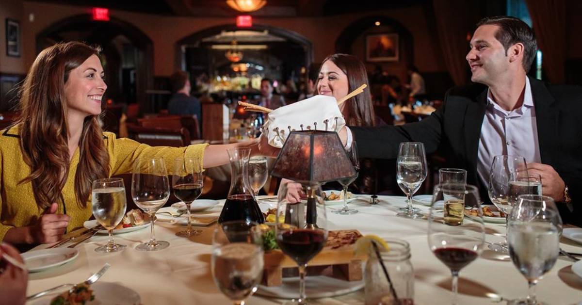 three people at a restaurant dining table