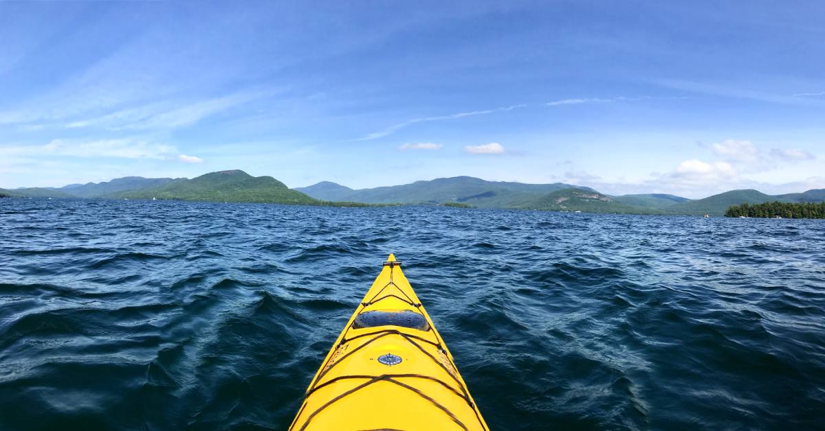 tip of yellow kayak in the water