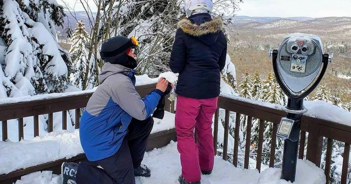 a skier proposing by scenic overlook