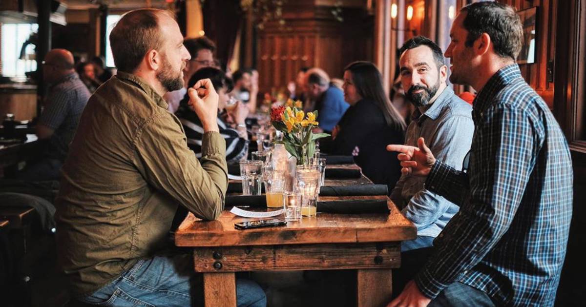 men at a table for happy hour