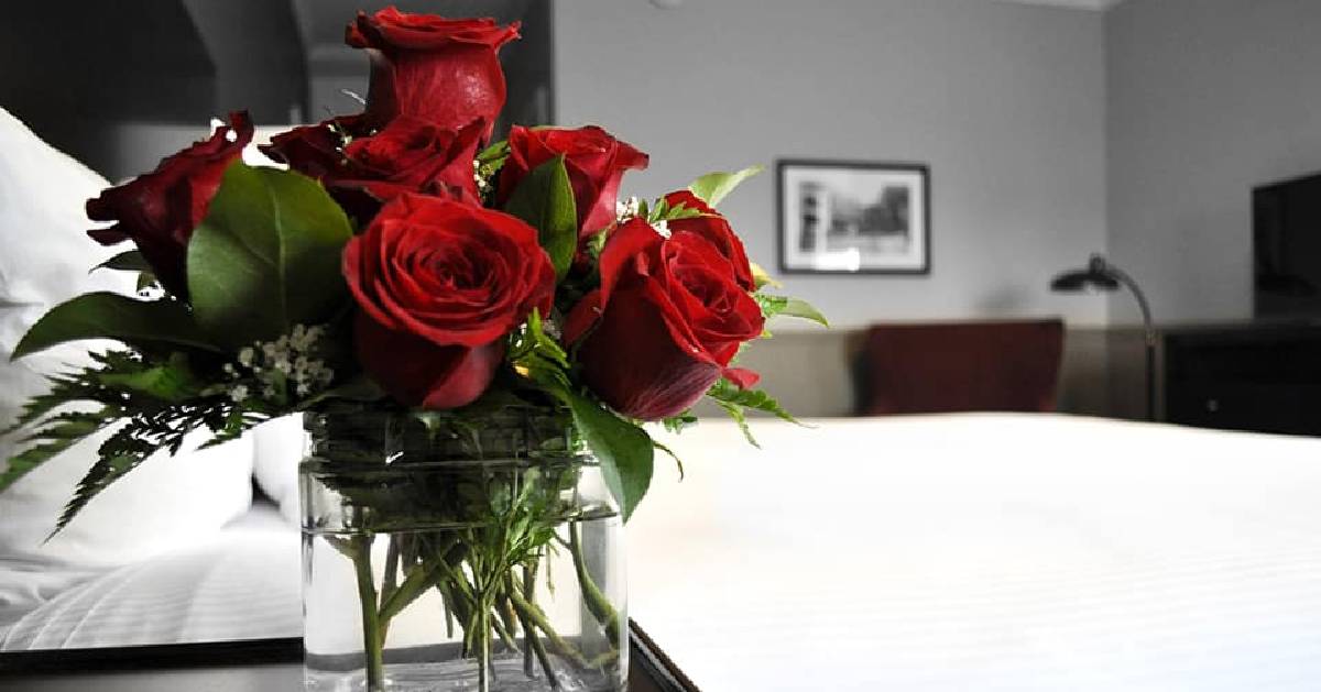 roses by hotel room bed