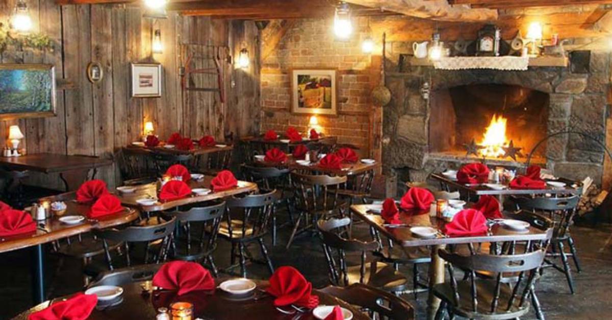 spacious dining room with stone fireplace in the back