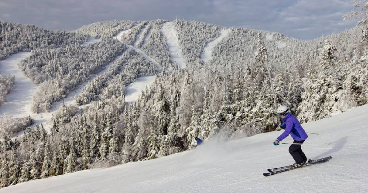 person skiing down a snowy slope