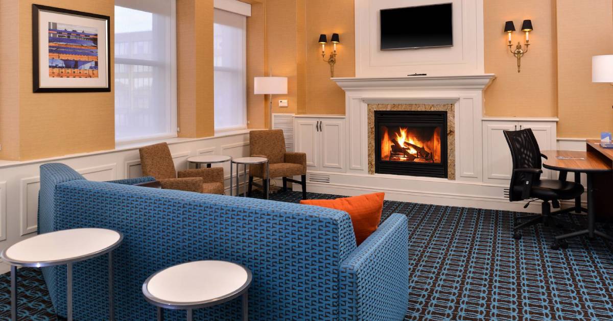 blue sofa and other furniture in a room with a fireplace