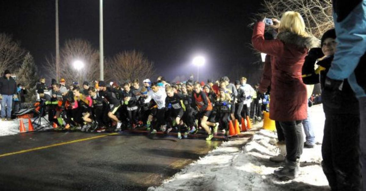 people running in a road 5K race at night