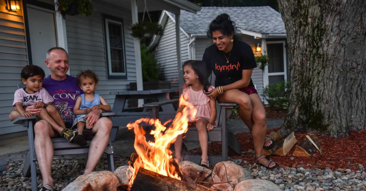a family in front of a fire pit 