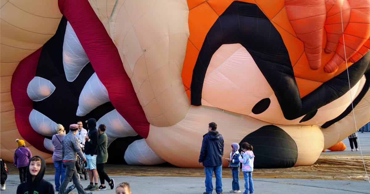 people and kids standing by Tasmanian devil hot air balloon starting to be blown up
