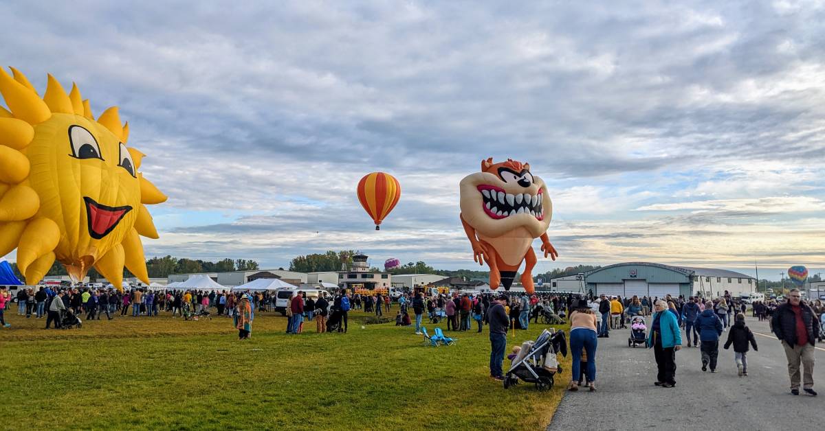people and hot air balloons at festival