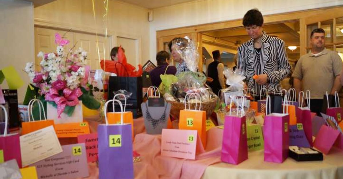 woman looking down at colored bags at a fundraising event
