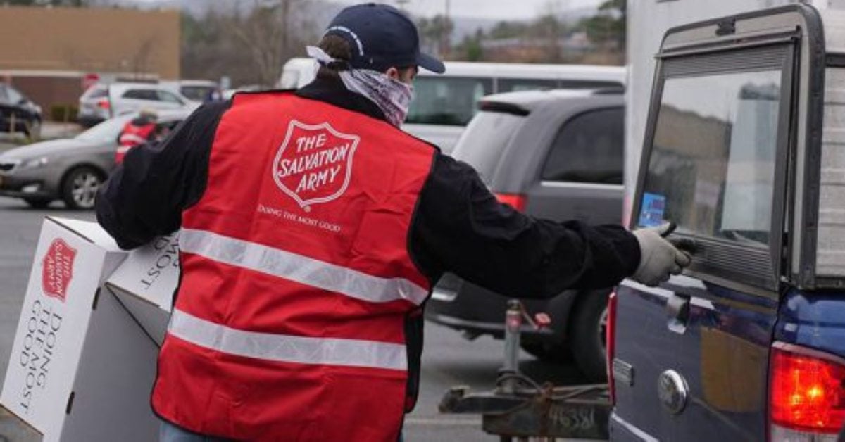 man wearing salvation army vest at a car