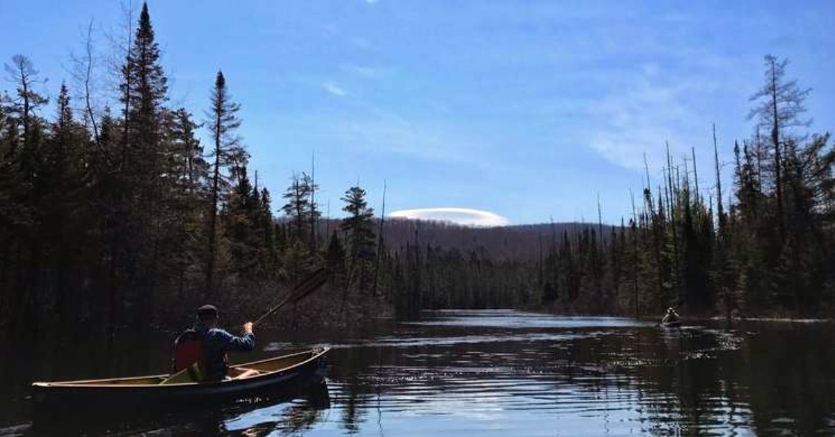 2 people paddling canoes on a river 