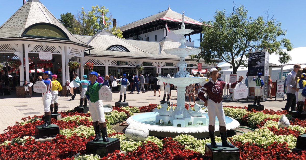 fountain and jockey statues outside of the saratoga racetrack entrance