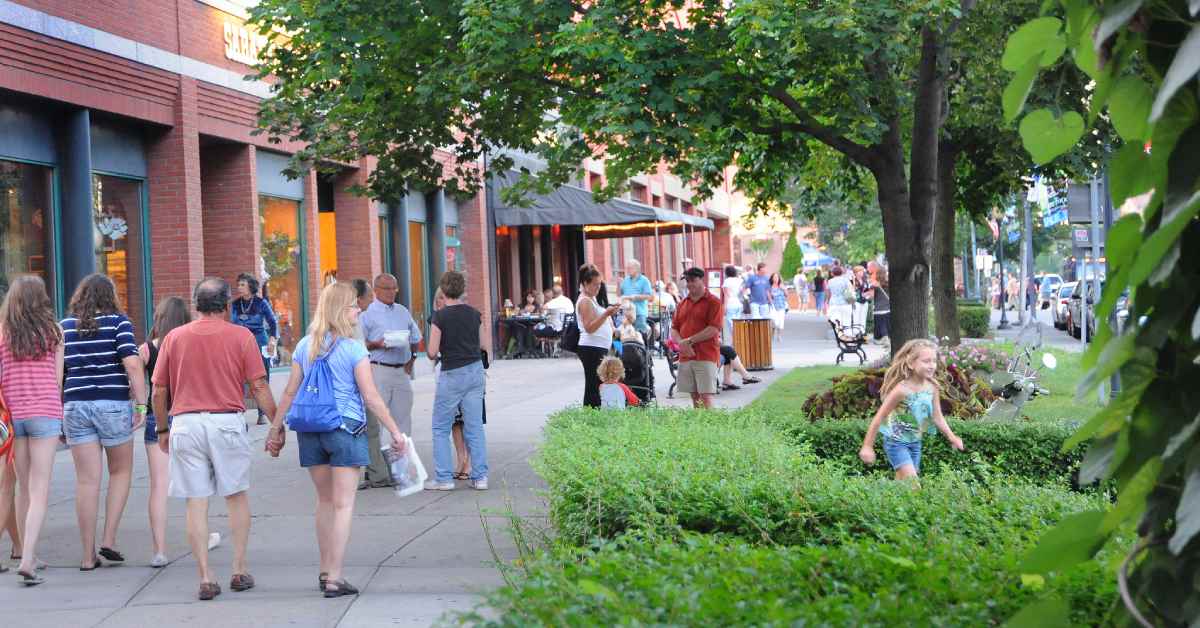 people walking along a sidewalk in a city