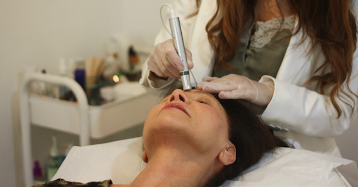 woman doing laser treatment on another woman