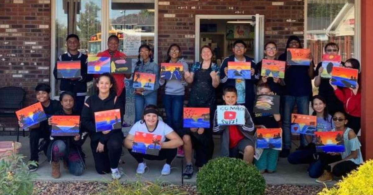 kids holding paintings from art in mind 
