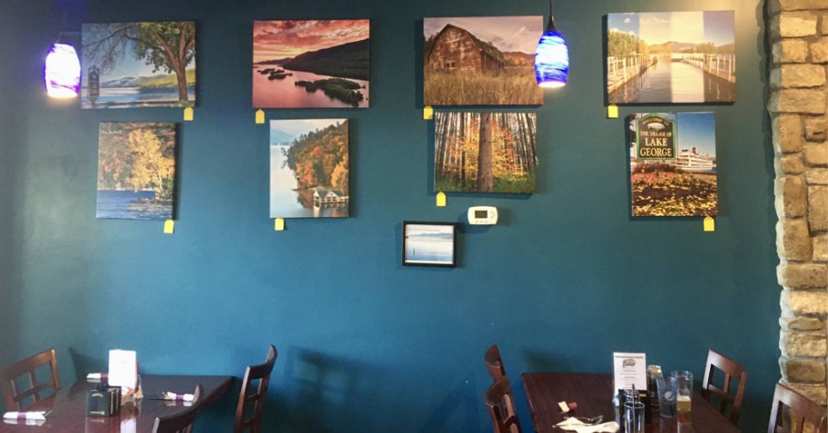 canvas prints hang on wall in coffee shop
